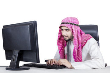 Wall Mural - Arabian man typing on keyboard