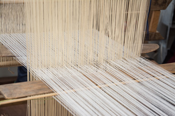 weaving silk in traditional way at manual loom. Thailand