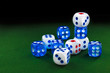 © makcoud - blue and white dices on the green velvet surface