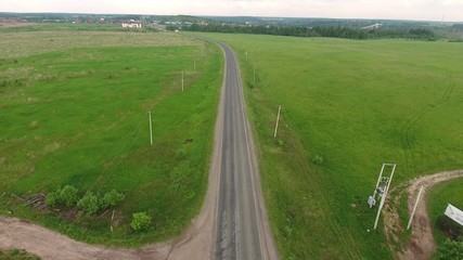 Sticker - Flying over country road passing through the green meadows in Moscow countryside. Russia
