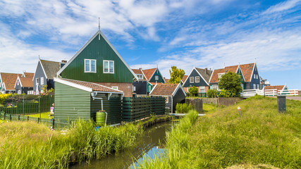 Wall Mural - Traditional Dutch fishing village scene with wooden houses and c