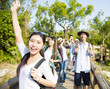 © Tom Wang - happy young group hiking together through the forest
