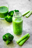 Fototapeta Kuchnia - Green vegetable smoothie in glass at gray background