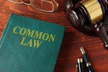 Book With Title Common Law On A Table.