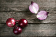 Fresh organic red onions on a wooden background