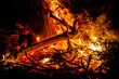 © MandriaPix - sparks and tongues of fire on branches and trunks burning in a big bonfire