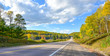 Summer highway open road to anywhere.
Sunny road  down a country highway in summer.  Warm day to drive or travel to anywhere.