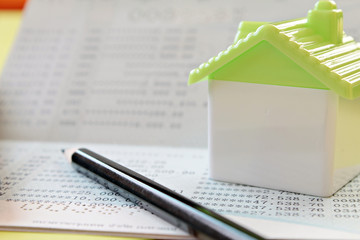 Business, finance, savings money or mortgage concept : Small house and pencil on savings account passbook