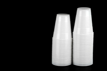 Stacking White Plastic Cups Isolated On Black Background