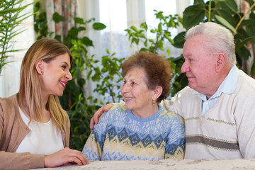 Wall Mural - Elderly couple with happy caretaker