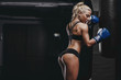 © Fotokvadrat - sexy young athletics muscled blonde girl relax after training with boxing gloves and lean to punching bag. Fitness muscled woman in sport clothing posing