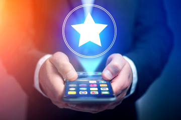 Poster - Businessman hand holding mobile phone with favorite star icon