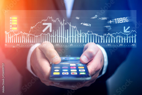 Fotografie, Obraz Trading data information going out the smartphone of a businessm