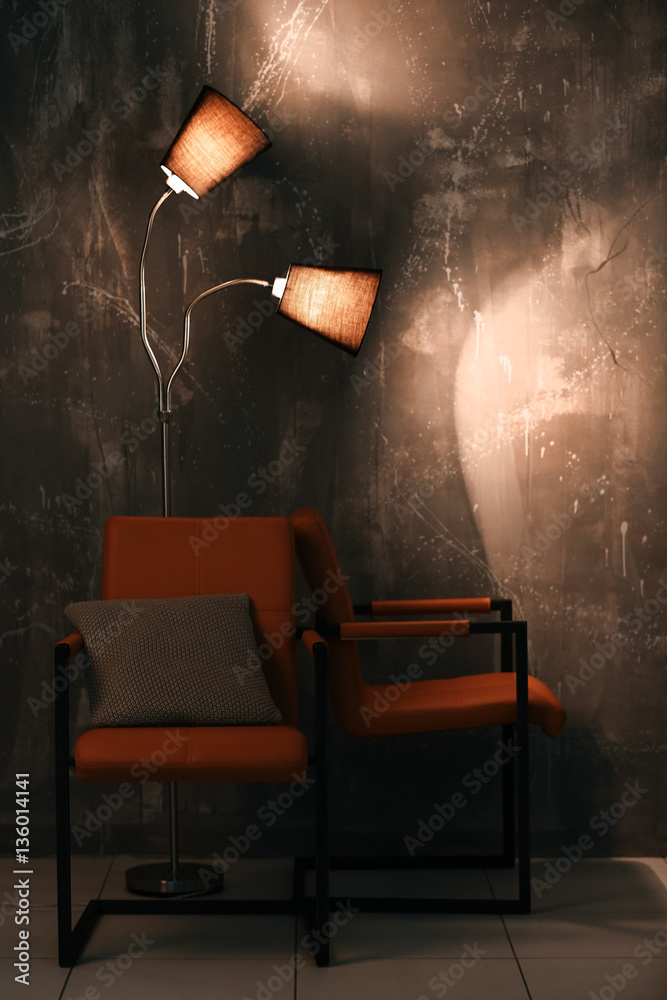 Modern chairs on wall background