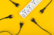 © kintarapong - Messy of electrical cords and wires unconnected electrical power strip or extension block  with messy wires, top view on colorful background, messy electric equipment flat lay concept.