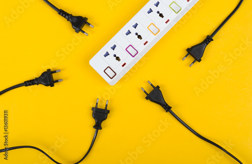 Cuadros en Lienzo Messy of electrical cords and wires unconnected electrical power strip or extension block with messy wires, top view on colorful background, messy electric equipment flat lay concept