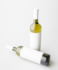 Two wine bottle are standing on gray background