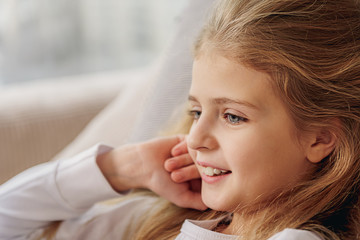 Wall Mural - Happy kid lying on sofa at home