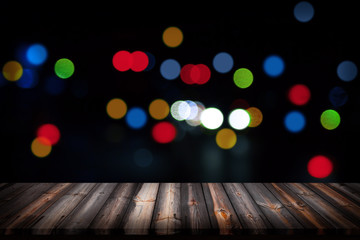 Wall Mural - wooden floor and city light with bokeh night background.