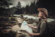 © Nejron Photo - Woman hiker searching right direction on map near wild mountain river