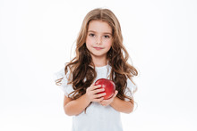 Pretty Curly Little Girl Standing And Holding Red Apple
