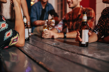 Wall Mural - Friends sitting around a table having drinks