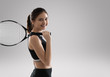 Studio portrait of beautiful girl tennis player with a racket.