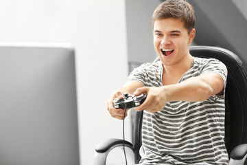 Canvas Print - Teenager playing videogame at home