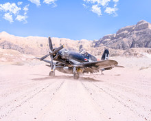 World War II Military Airplane Taking Off In The Desert