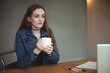© Wavebreak Media - Thoughtful woman having cup of coffee