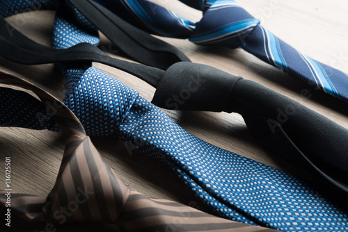 Carta da parati  Silk neck ties on wooden background.