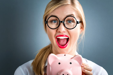  Young woman with a piggy bank