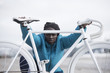 © Alberto Lessmann/ADDICTIVE STOCK - Portrait of young woman with white bicycle