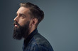 © Fxquadro - Side view of bearded male over grey background.