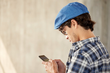 close up of man texting message on smartphone