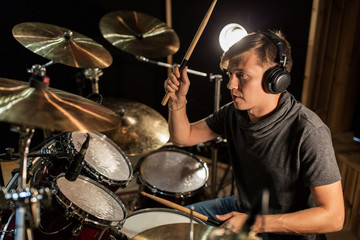 Wall Mural - male musician playing drums and cymbals at concert