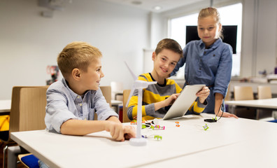 Wall Mural - kids with tablet pc programming at robotics school