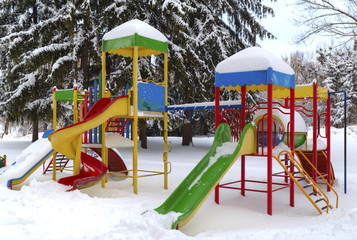 Children's playground covered with snow in winter