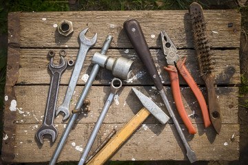 On weathered old wooden surface lie the tools