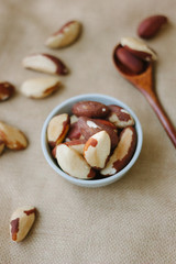 Poster - Brazil nuts in white ceramic bowl.