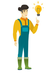 Wall Mural - Farmer pointing at bright idea light bulb.