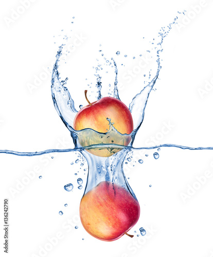 Obraz w ramie Apples falling under water with a splash on white background