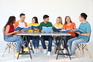 Poster - Group of people reading books while sitting at table