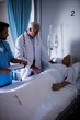 © WavebreakMediaMicro - Doctors comforting senior patient on bed