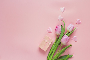 Wall Mural - Romantic background with tulips and gift box on pink. Space for