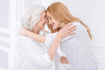 Wall Mural - Positive adult woman and her moter expressing love