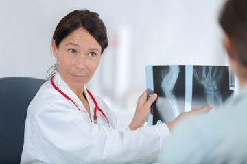 female doctor shows x ray to patient