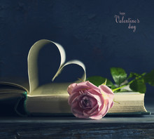 Old Book Page With A Heart-shaped Valentine's Day And A Pink Rose