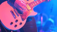 Close-up - Man Playing On An Electronic Guitar With Mediator On A Concert