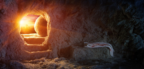tomb empty with shroud and crucifixion at sunrise - resurrection of jesus